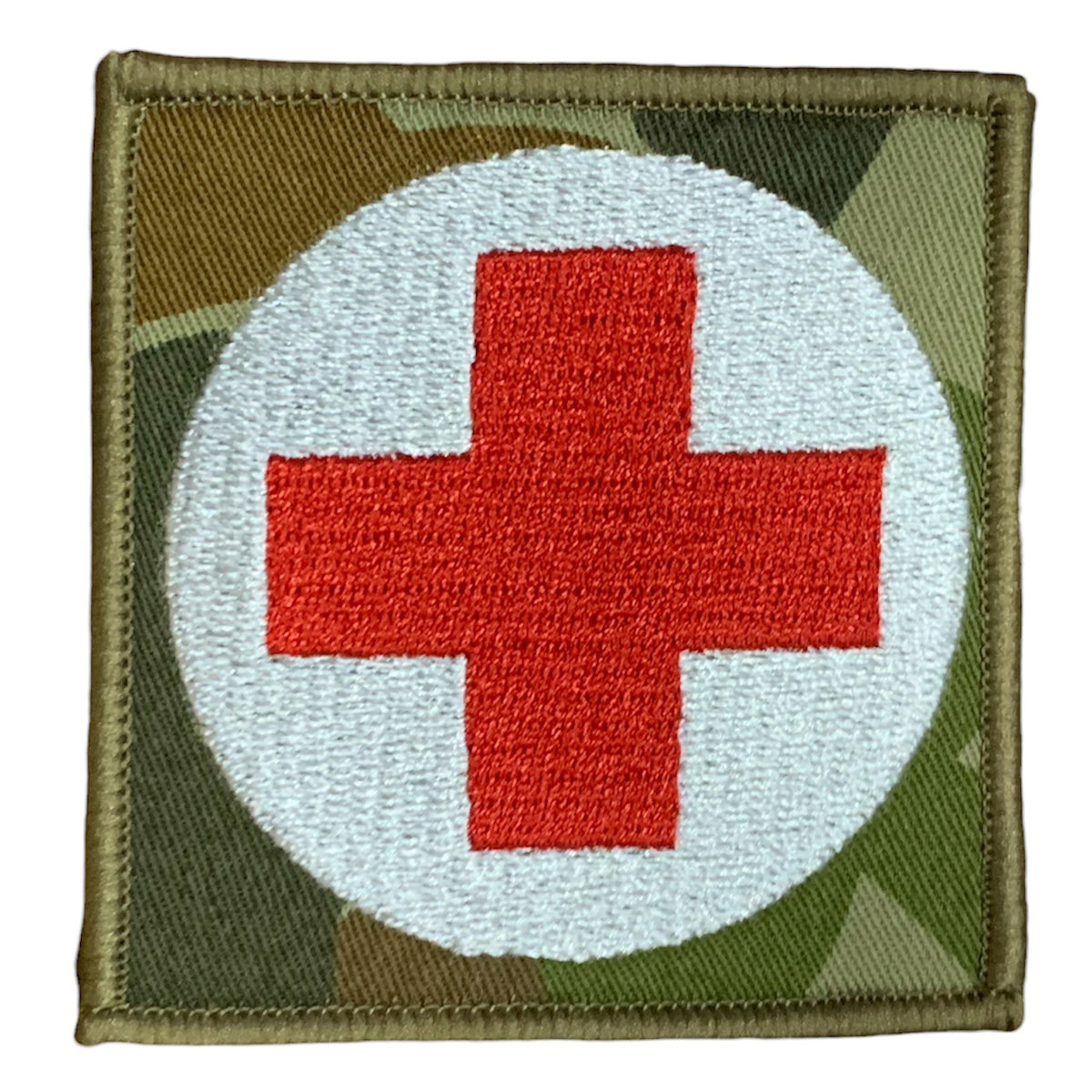This Military Combat Patch, with the option of Plain or Velcro backing, is an essential for First Aid personnel in the field. Made from high-quality materials, this patch features an Australian-made field medical symbol and can easily be attached to First Aid Kits, Packs, or arm bands. Its exceptional quality is evident with overlocked edges and a size of 65mm x 65mm. Plus, it's proudly made in Australia using Auscam Fabric. www.moralepatches.com.au