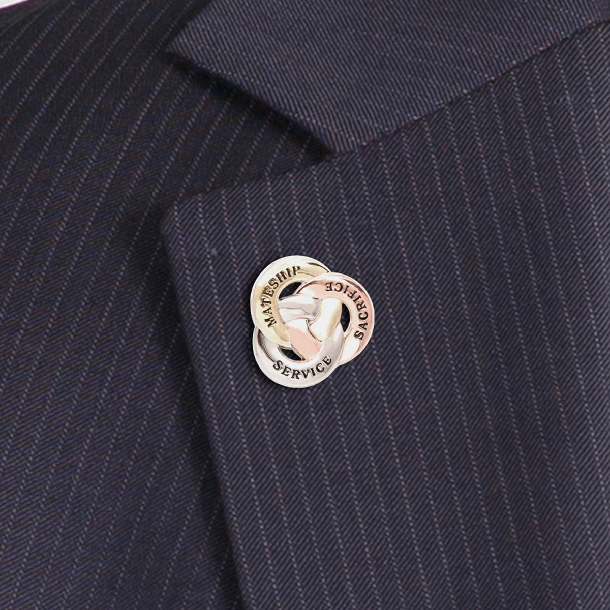 Crafted with meticulous attention to detail, this lapel pin features three interlocked rings made of zinc alloy, each with a unique message. One ring in copper is engraved with "Sacrifice", another in silver with "Service", and the third in gold with "Mateship". Together, they symbolize the unwavering values that Australian soldiers hold dear. www.moralepatches.com.au
