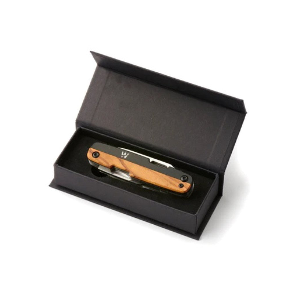 This versatile EDC knife features a plain blade with a convenient finger hole, complemented by a flat head screwdriver, scissors, and a Phillips screwdriver with a cap lifter. Crafted with a black and olive wood handle and a 5.7 cm 12CR27 steel blade, it offers durability and style. Compact at 8.75 cm closed length and weighing just 108g, it’s perfect for everyday carry. Presented in a premium card gift box, it makes an excellent gift for practical use. www.moralepatches.com.au