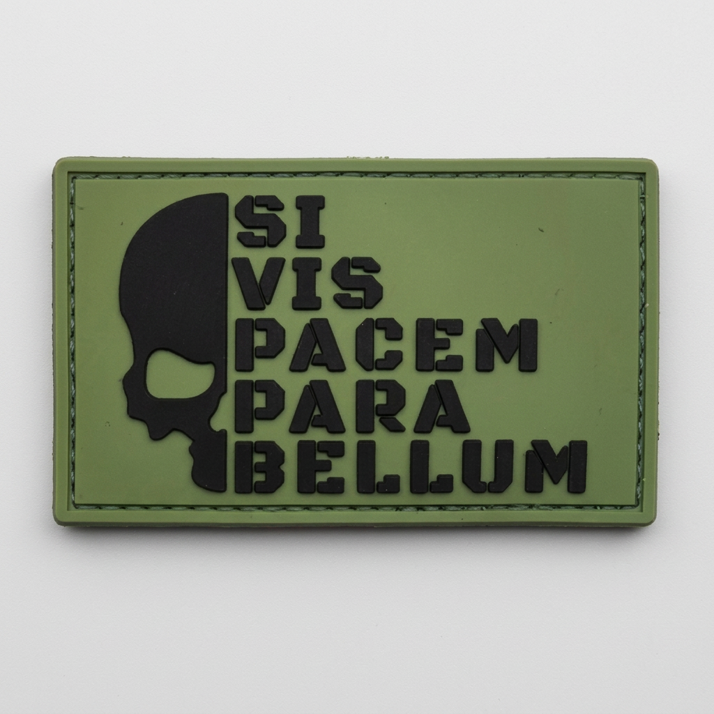 Green Para Bellum PVC patch on a light grey studio background