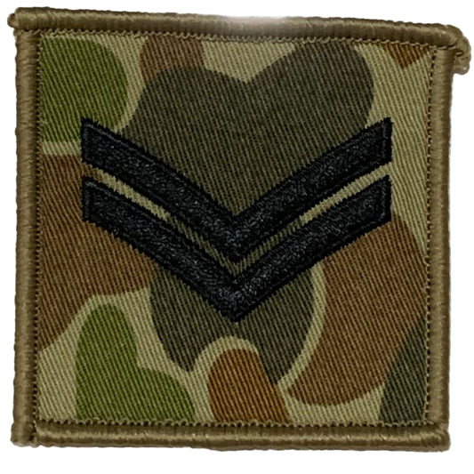 DPCU Rank Patch Corporal Auscam  Corporals are the first rank above Lance Corporal, these soldiers are experienced in their field of skill and have been targeted for leadership capabilities.  These soldiers have had the training and are in the more experienced field of leadership.  Usually they are in command of a section of soldiers.  Size: 6.5cm x 6.5cm  Available with plain or velcro backing