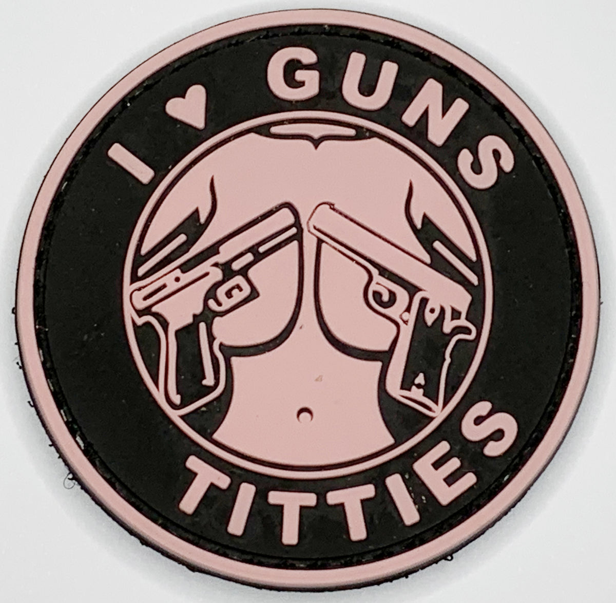 I Love Guns and Titties PVC Patch, Velcro backed Badge. Great for attaching to your field gear, jackets, shirts, pants, jeans, hats or even create your own patch board.  Size: 6cm